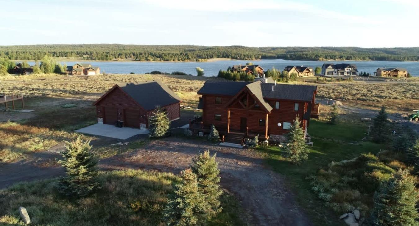 Whether it's the log walls, the expansive windows, or the inviting porch, everything about the exterior invites you to relax and immerse yourself in the beauty of nature.