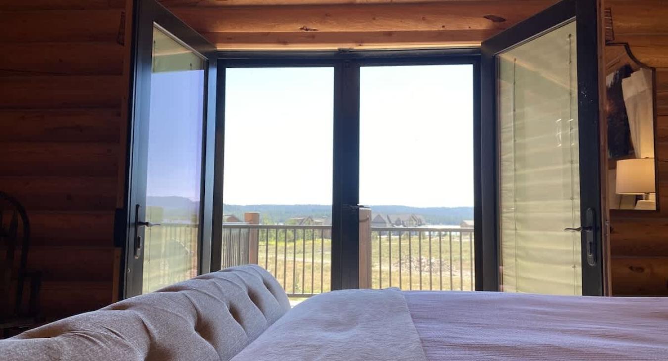 The master bedroom features log walls that create a calm and relaxing environment.