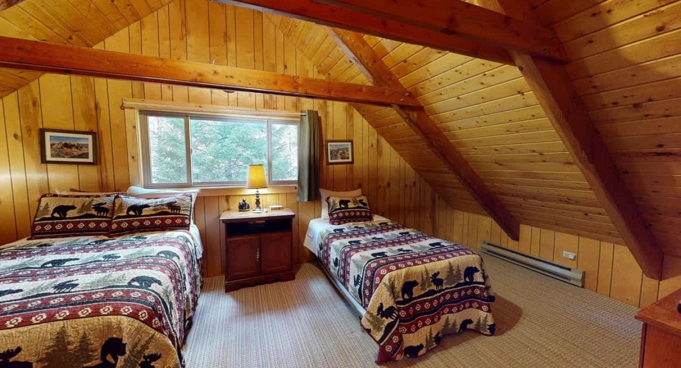The upstairs bedroom has a large window to view all of your surroundings.