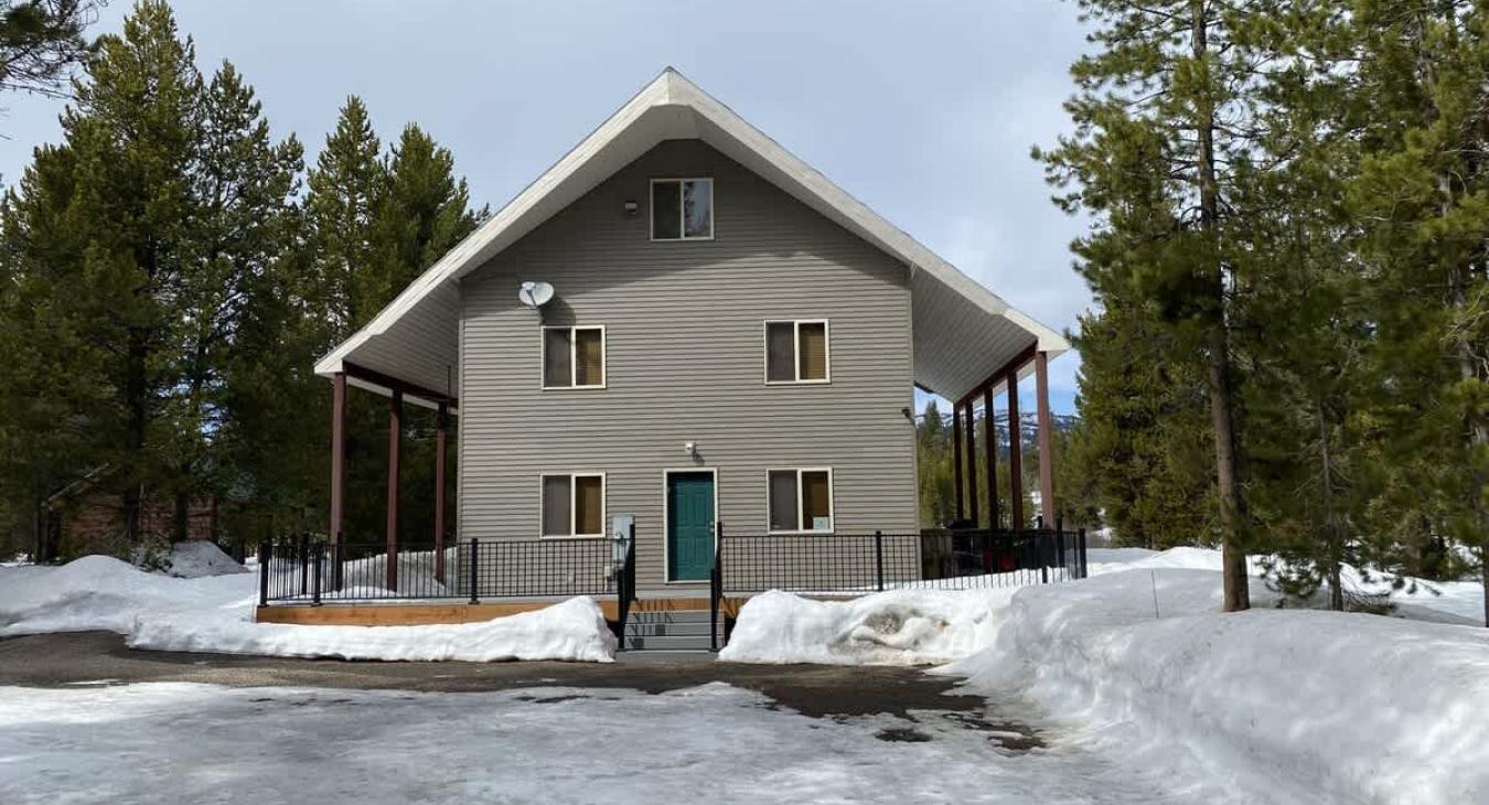 Beautiful cabin that is nestled in the towering pine trees.