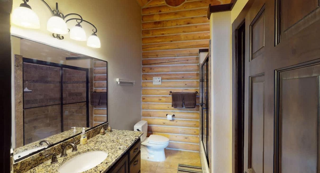 2nd bathroom upstairs located in the East Wing with a shower/tub combo, toilet, and sink vanity.