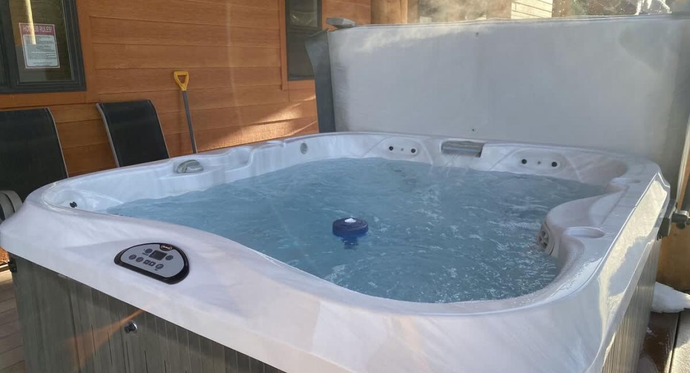 Hot tub located on the back deck to use during your stay.