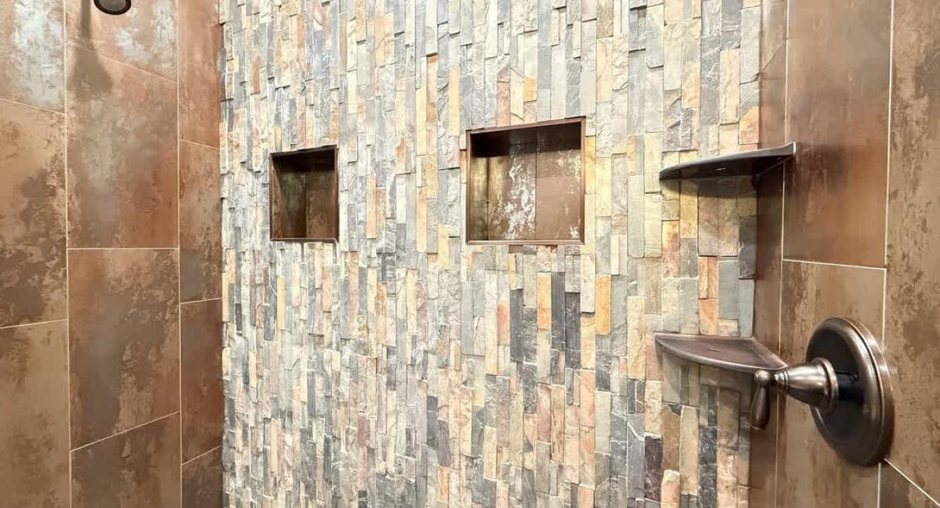 Rustic tiled master shower.