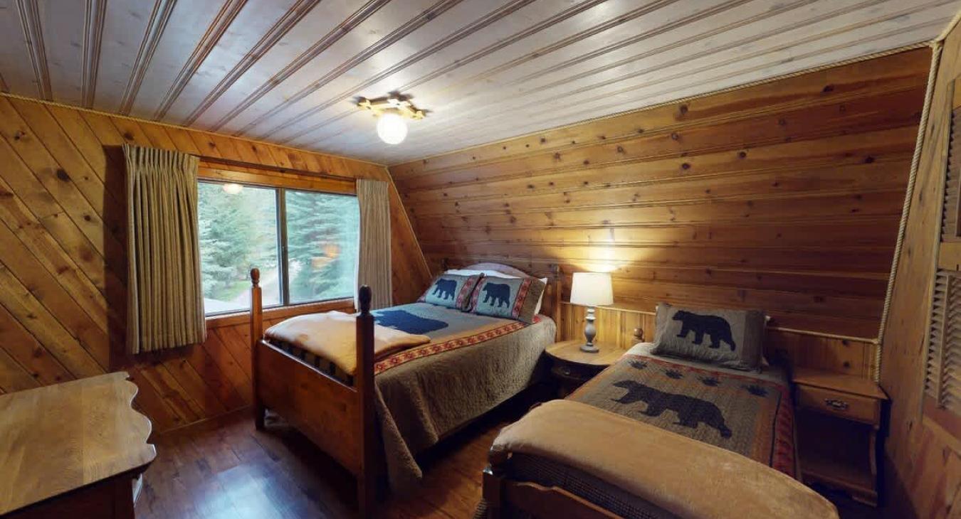 Bedroom #3 located upstairs with a Queen and a single bed.