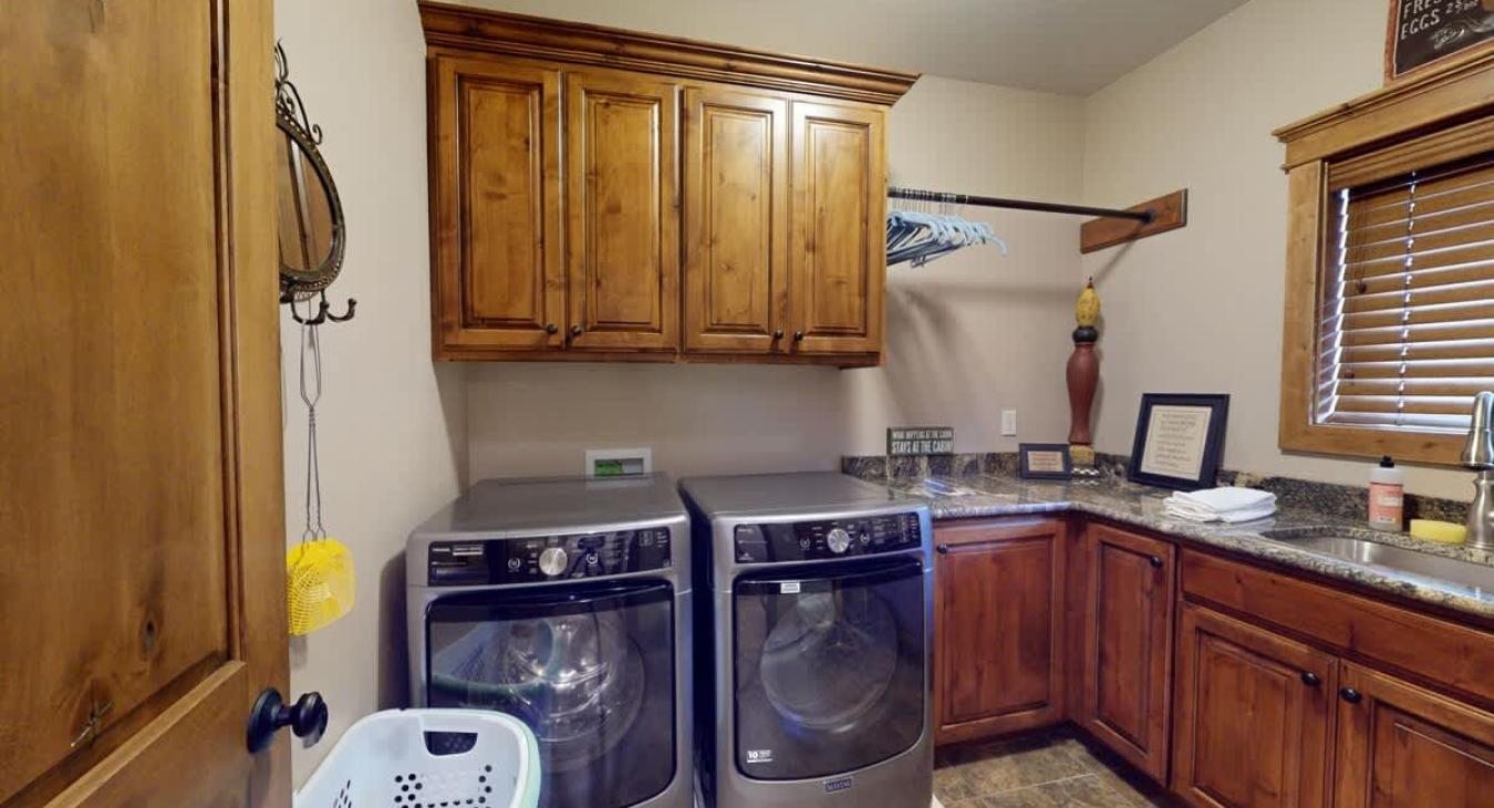 Laundry room with full size washer and dryer. Laundry soap is provided to you during your stay.