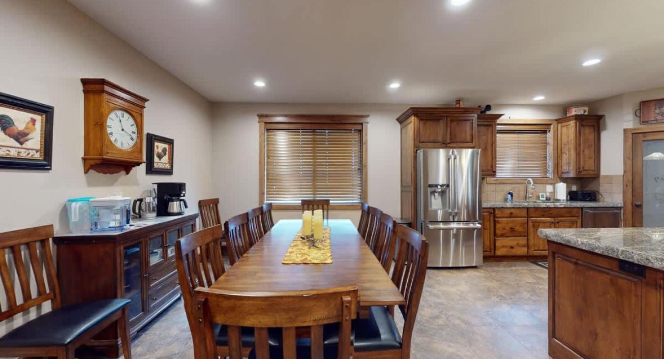 Dining room table located adjacent to the kitchen with space for everyone.
