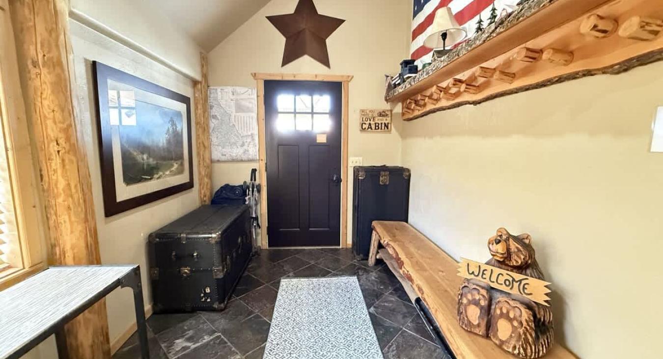 The entryway of the cabin has seating and storage during your stay.
