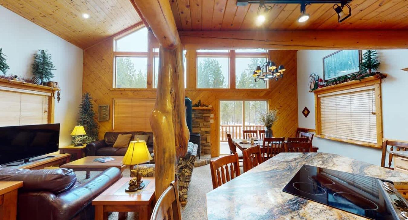 The space is flooded with natural light, thanks to large floor-to-ceiling windows that stretch across one entire wall.