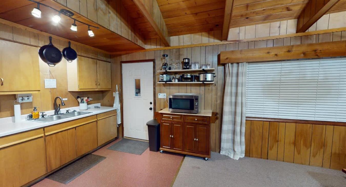 The entrance leads you right to the kitchen where you can enjoy homecooked meals from the comfort of the cabin.