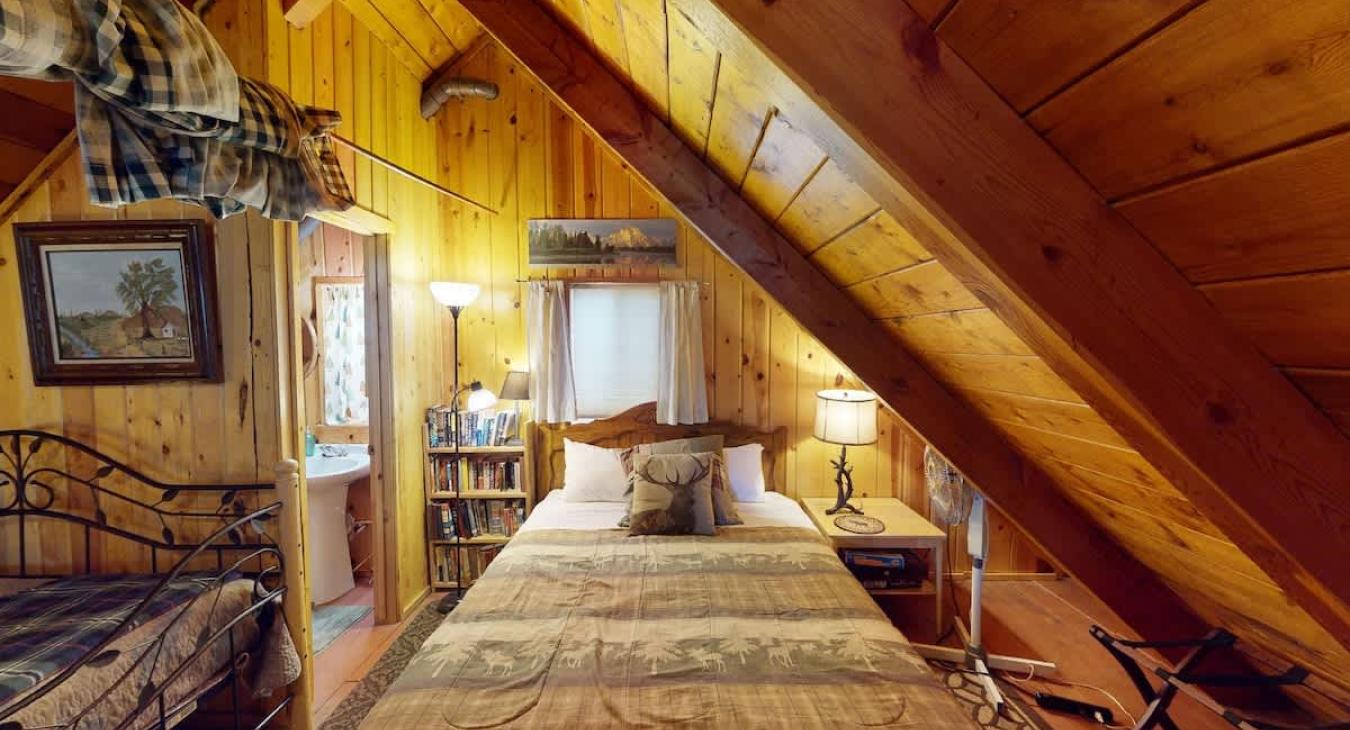 Loft area located up the stairs with 1 double bed and 2 twin beds.