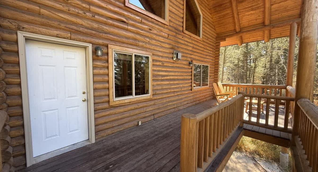 Outside deck with seating to enjoy the beautiful landscape of the cabin.