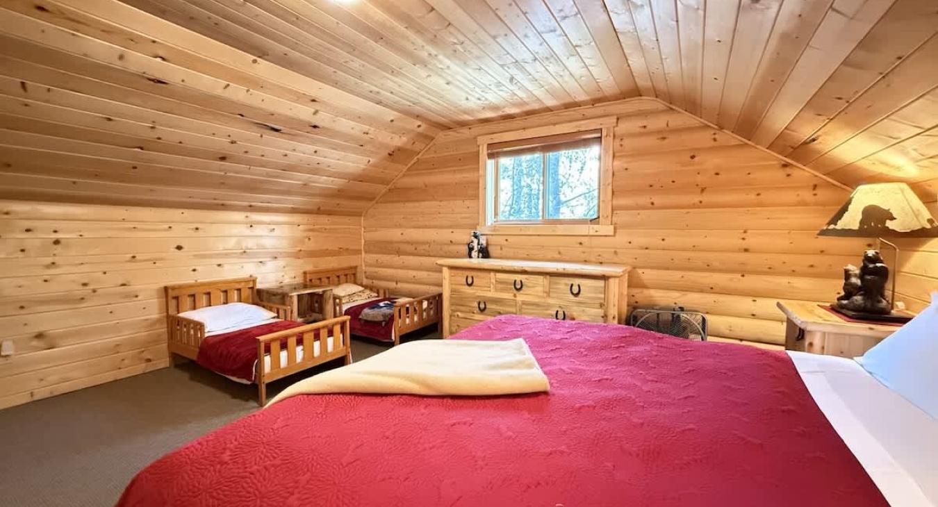 King upstairs bedroom with dresser and small closet. Also 2 kids beds. (Bring your own bedding)