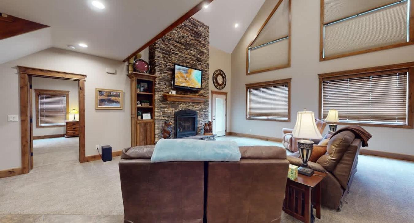 Open living room with fireplace and tv for entertainment.