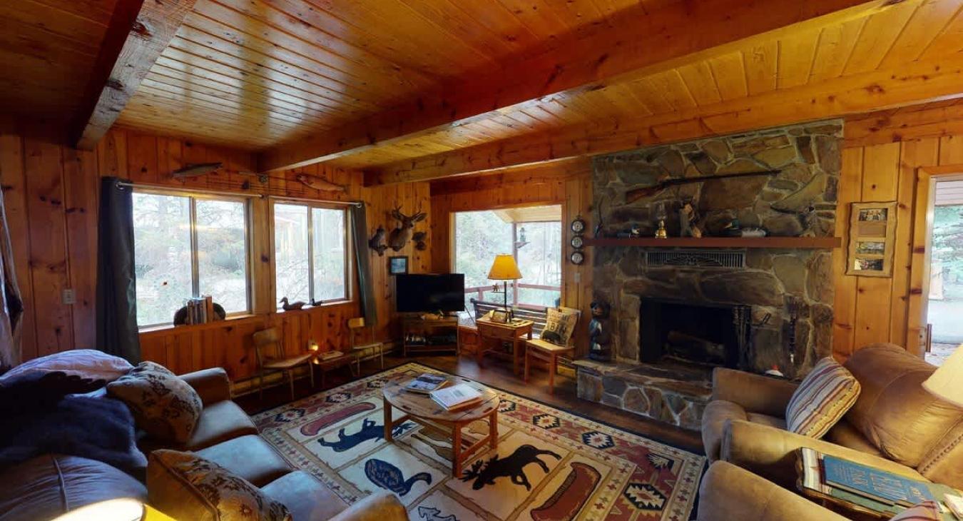 The living room offers a cozy space to unwind after a long day. A fireplace is included be sure to bring your own wood.