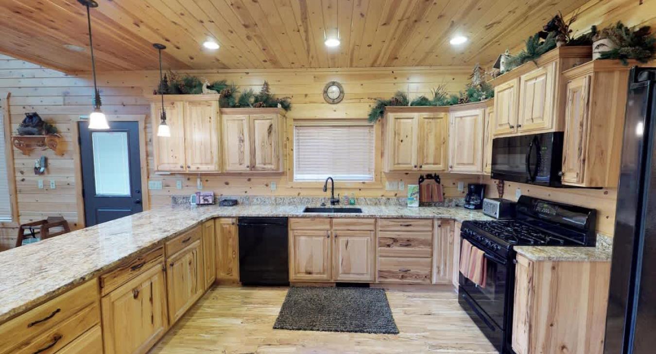 Full size kitchen equipped with appliances, pots and pans, dishes, utensils, and basic cooking essentials.