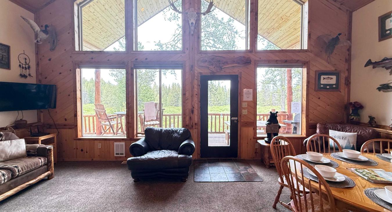 Natural light pours in through large windows, tying it all together with a view of the forest just beyond.