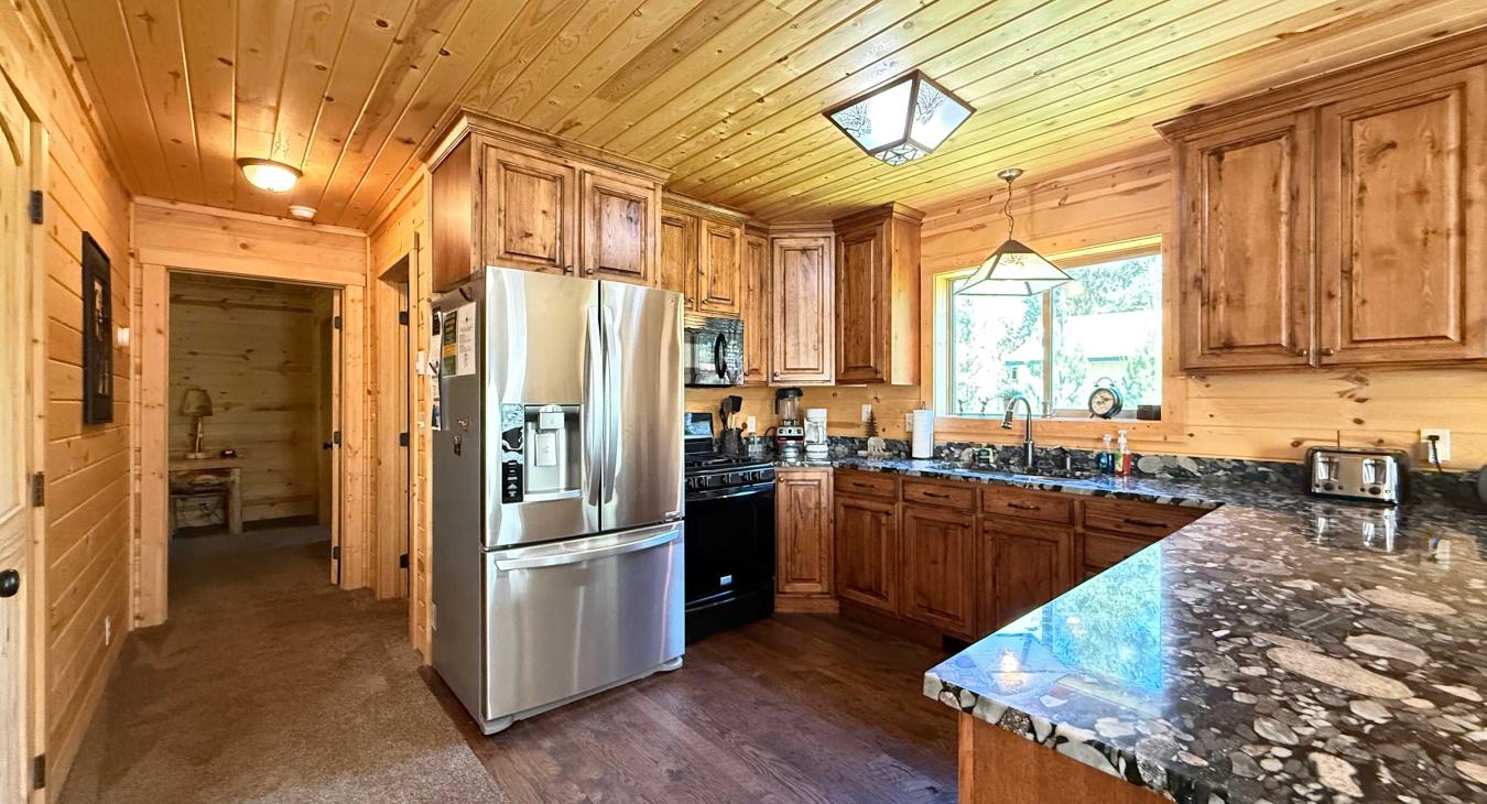 Whip up delicious family meals in the gourmet kitchen, beautifully finished with premium granite countertops, rich wood cabinetry, and stainless steel appliances.