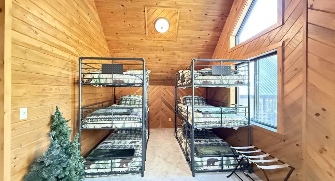 In the loft area 2 triple bunk beds. Comfortably sleeps 6 kids.