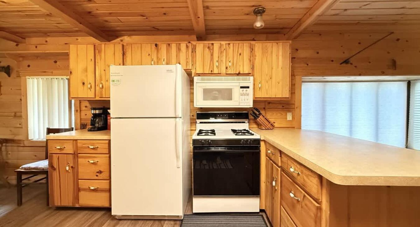 The open kitchen in this cabin is both functional and full of rustic charm, designed to bring people together.