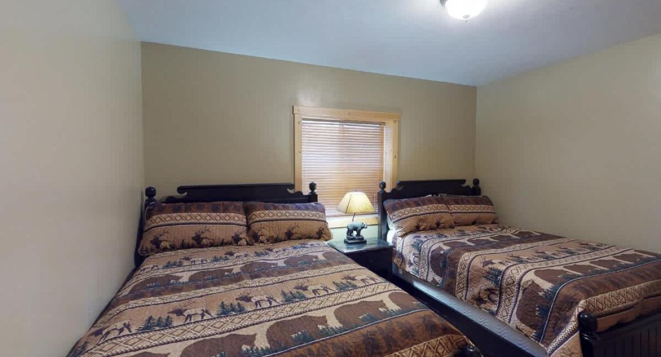 Bedroom #4 located in basement with 2 Queen size beds.