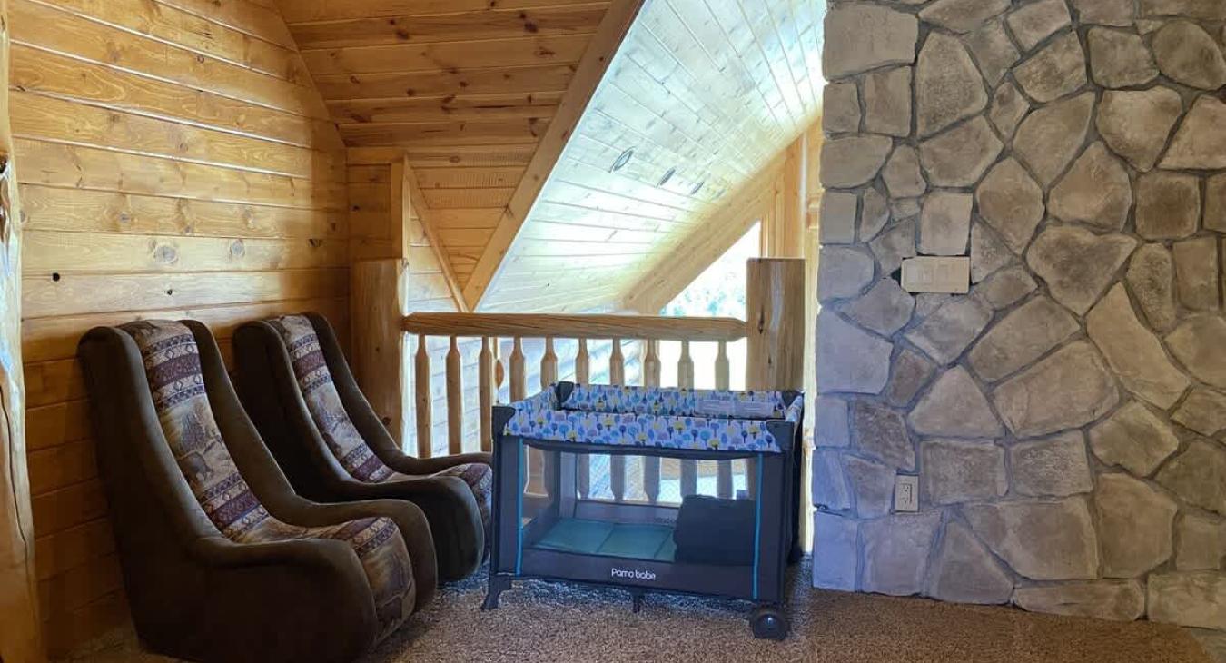 Located within the loft is two comfortable chairs and a pack and play for you to use for your little ones.