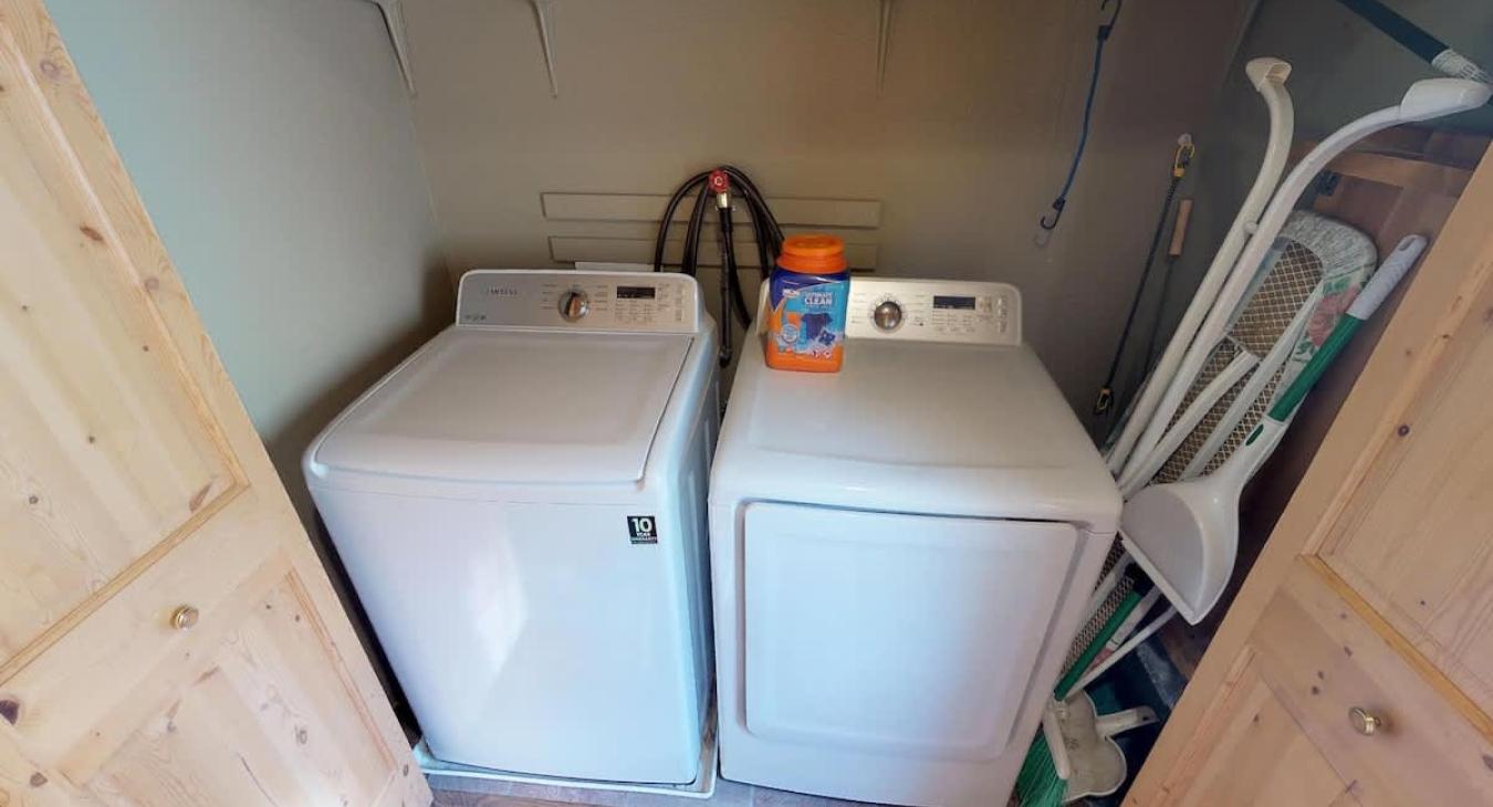 Laundry closet with full size washer and dryer. Laundry soap is provided.