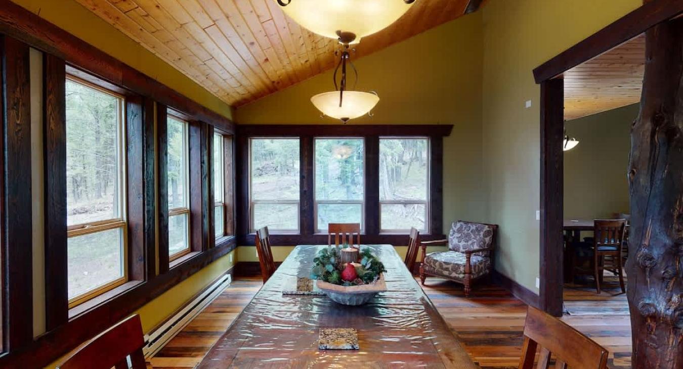 Large dining table that is located next to the kitchen.