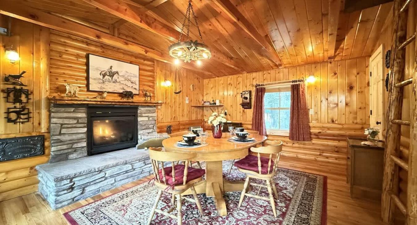 Entrance into the dining area with a dining table and a propane fireplace.
