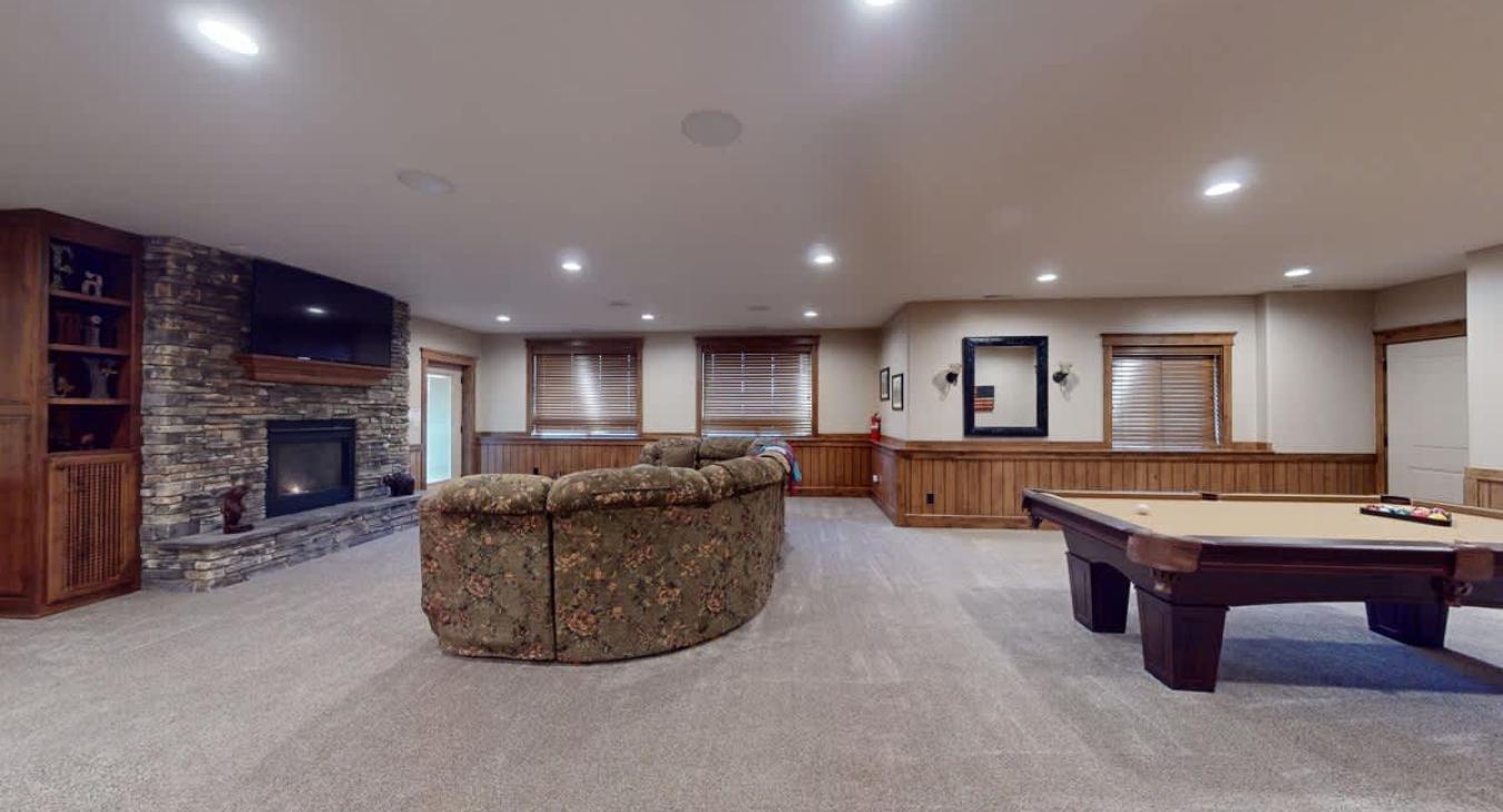 Basement living area with lots of space, seating, and entertainment.