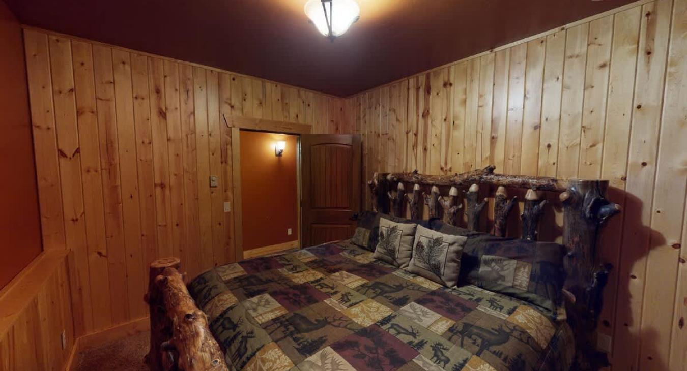 Bedroom #4 located in the basement with a King size bed.