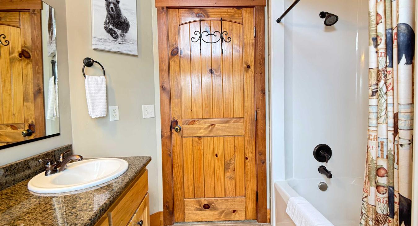 A clean and fully equipped upstairs bathroom featuring a convenient shower-and-tub combo and a toilet, perfect for a relaxing soak.