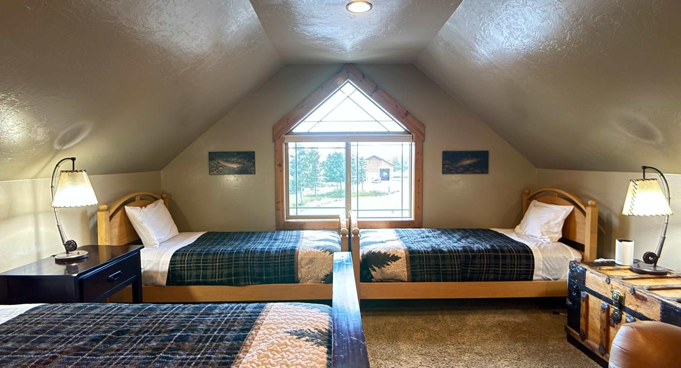Tucked perfectly under the geometric window are two additional twin beds, allowing this huge loft to comfortably sleep 4 to 6 guests.