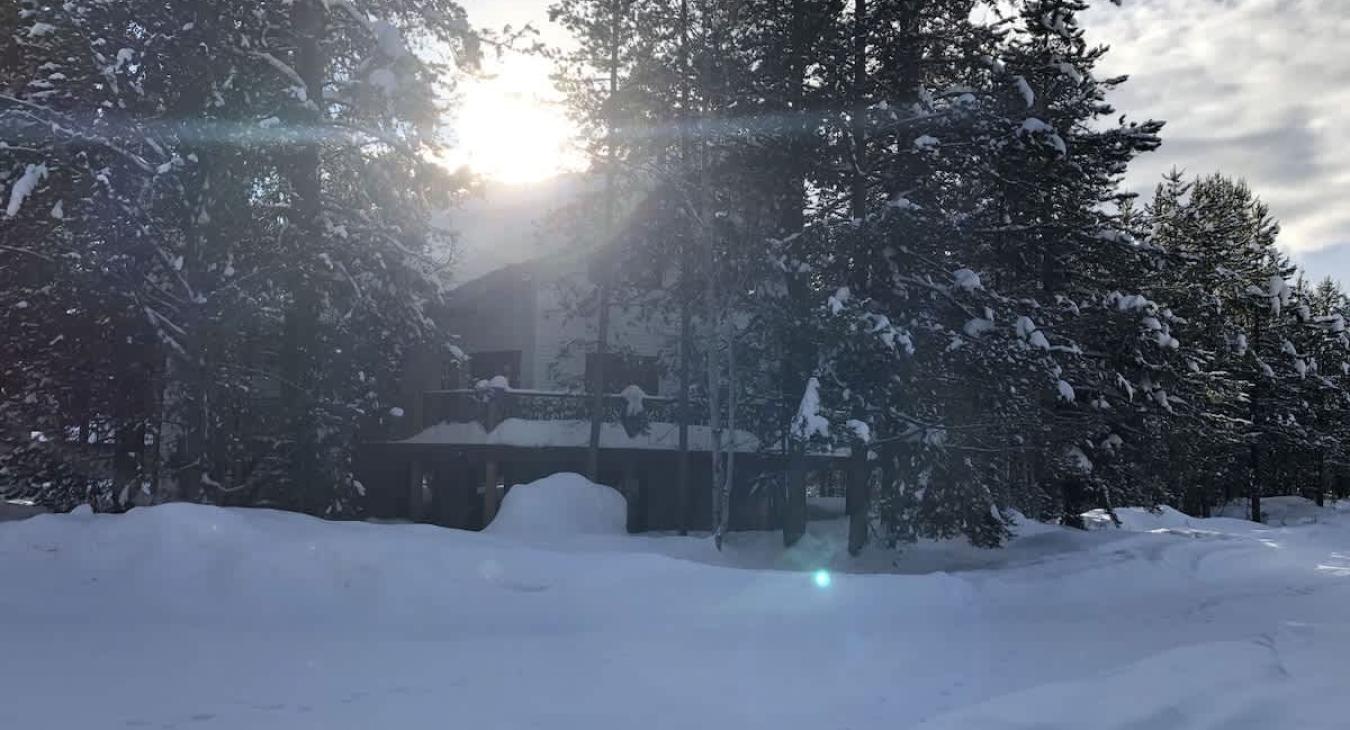 Welcome to Winchester Lodge with a beautiful view of the cabin from the road in the winter.