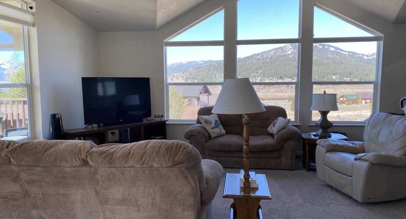 Living room area with seating and tv for entertainment.