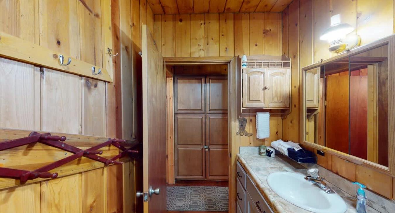 Bathroom located in the first door of the hallway.