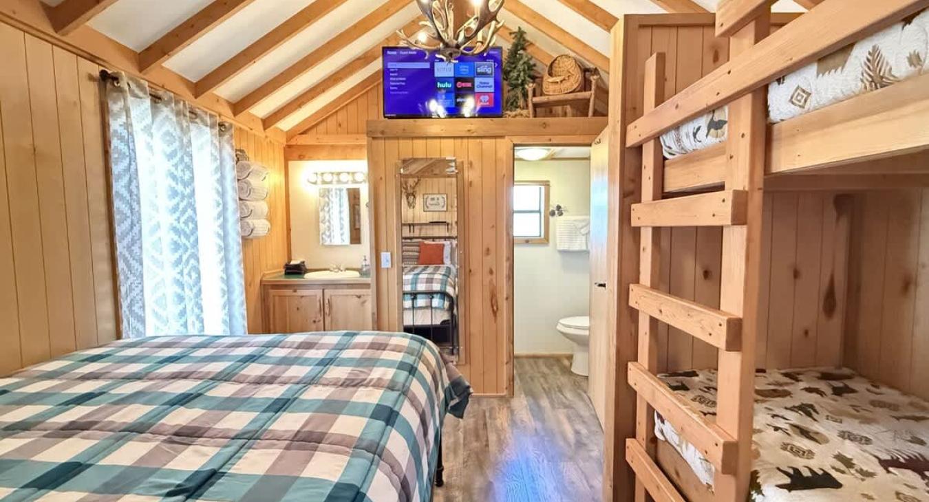 The cozy cabin also has a comfy queen bed to get a good nights rest. A vanity and sink is also available for getting ready for bed or getting ready for your day exploring Yellowstone.