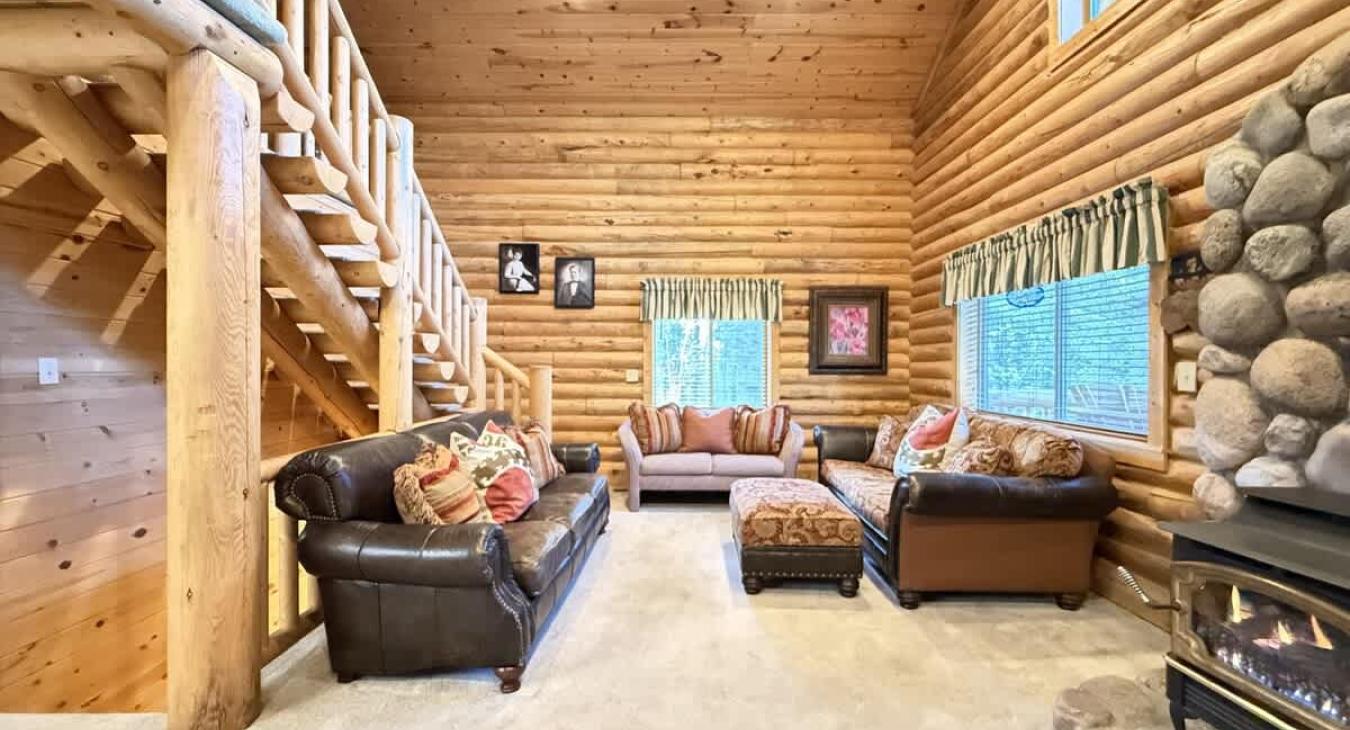 The open kitchen blends seamlessly into the cabin's cozy living area, creating a welcoming space perfect for gathering and unwinding.