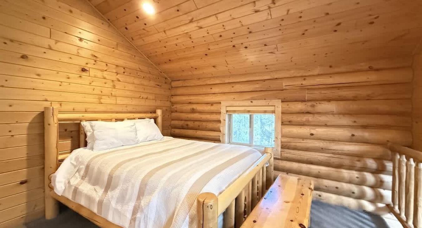 A queen bed is located upstairs in the loft.