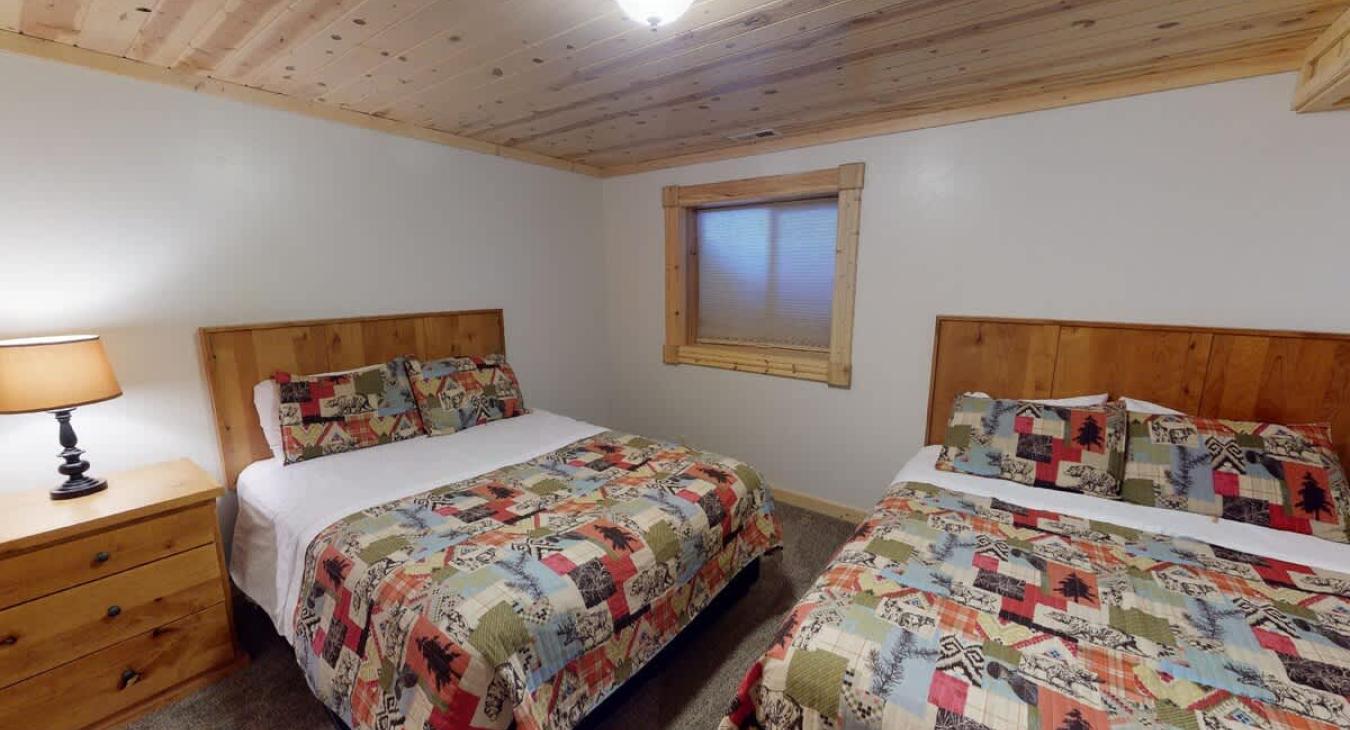 Bedroom #6 located downstairs with 2 Queen beds.