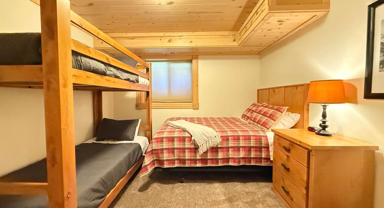 Bedroom #5 located downstairs with Queen bed and bunk bed,