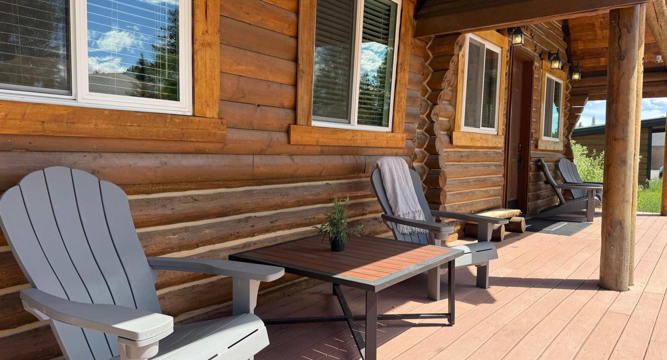 Enjoy your morning coffee on the spacious covered front porch, complete with comfortable Adirondack chairs and a small coffee table.