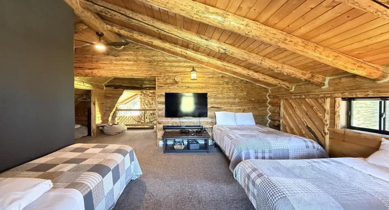 Beds are located facing a tv for entertainment.