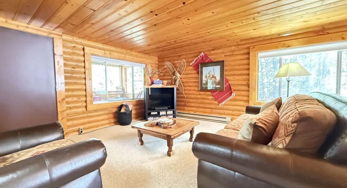 Living room with seating and smart tv.