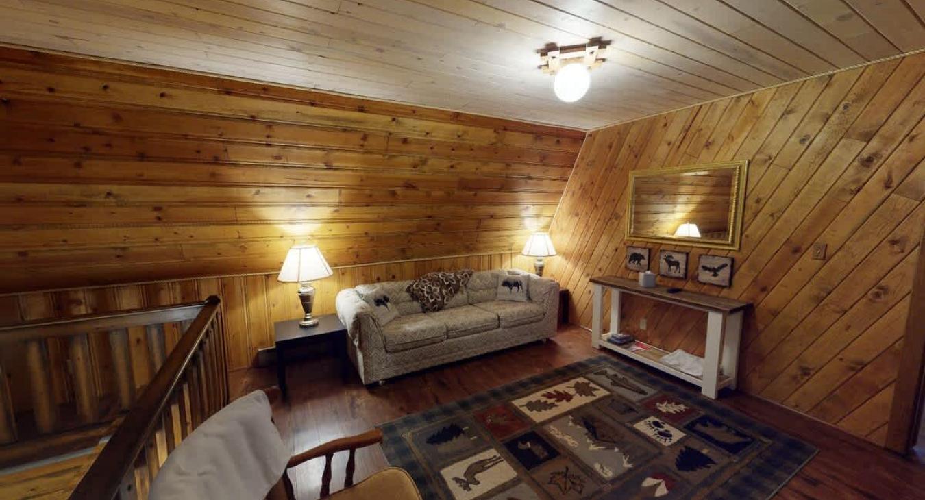 Upstairs loft with couch and seating.
