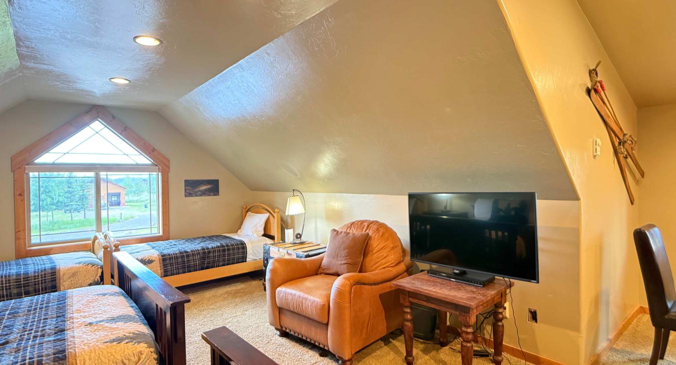 Relax in the cozy leather armchair and catch up on your favorite shows, positioned right alongside the room's comfortable sleeping layout.