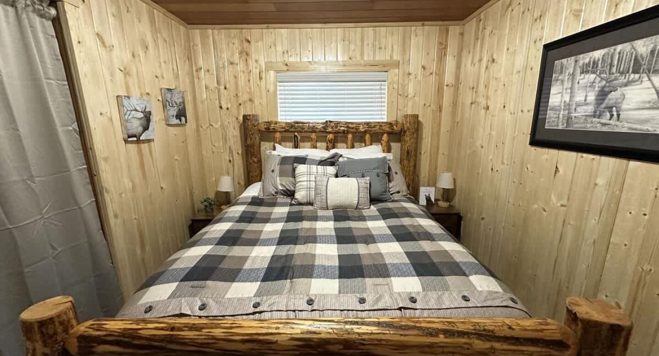 Queen bedroom with flat screen smart tv and closet