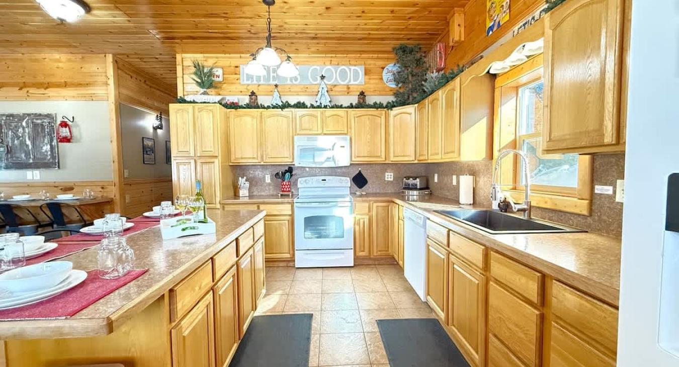 This kitchen is equipped with full appliances, basic cookware, dishes, and spices.
