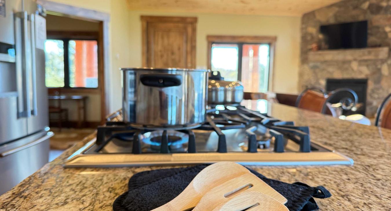Basic cooking essentials with pots and pans, dishes, silverware, and small appliances.