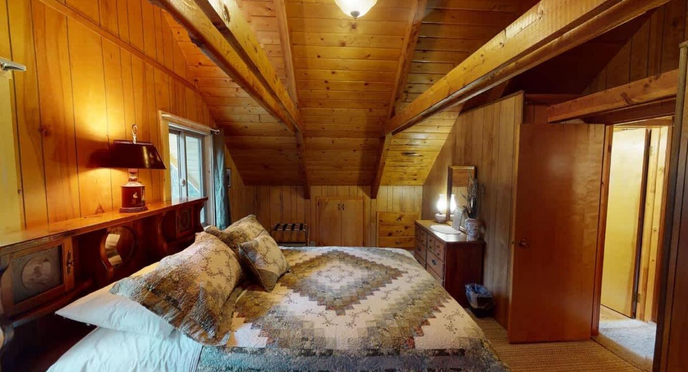 Upstairs bedroom with a queen bed.