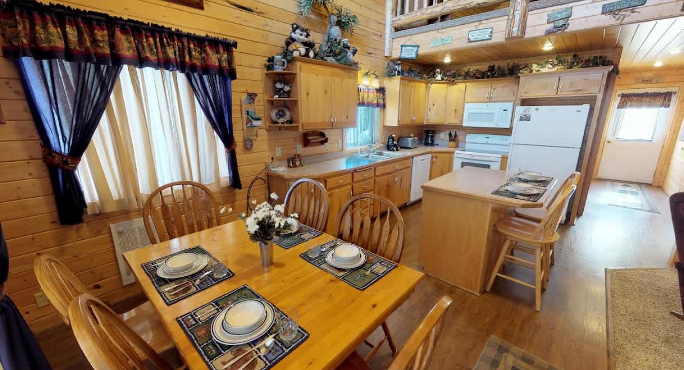 Upon entrance you are greeted by the dining table and kitchen.